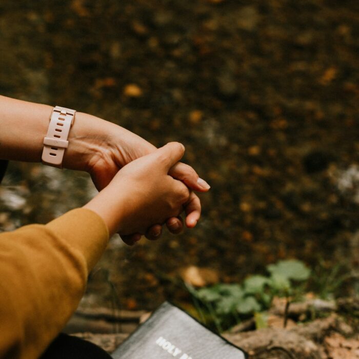 person wearing white band ring